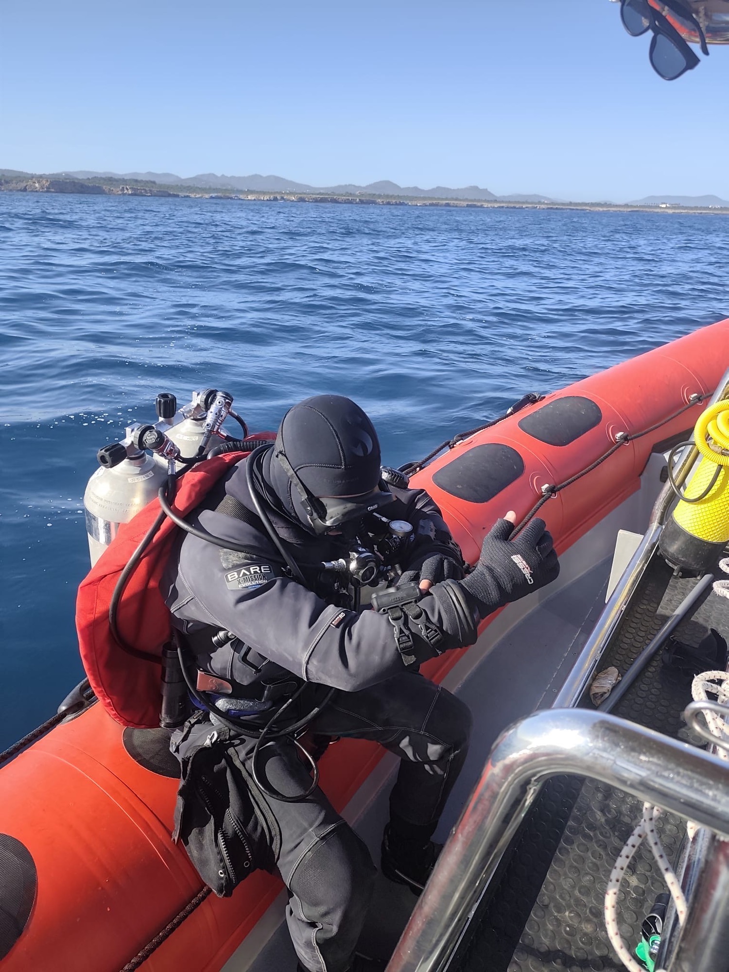 Diver preparing to enter the water from the boat edge