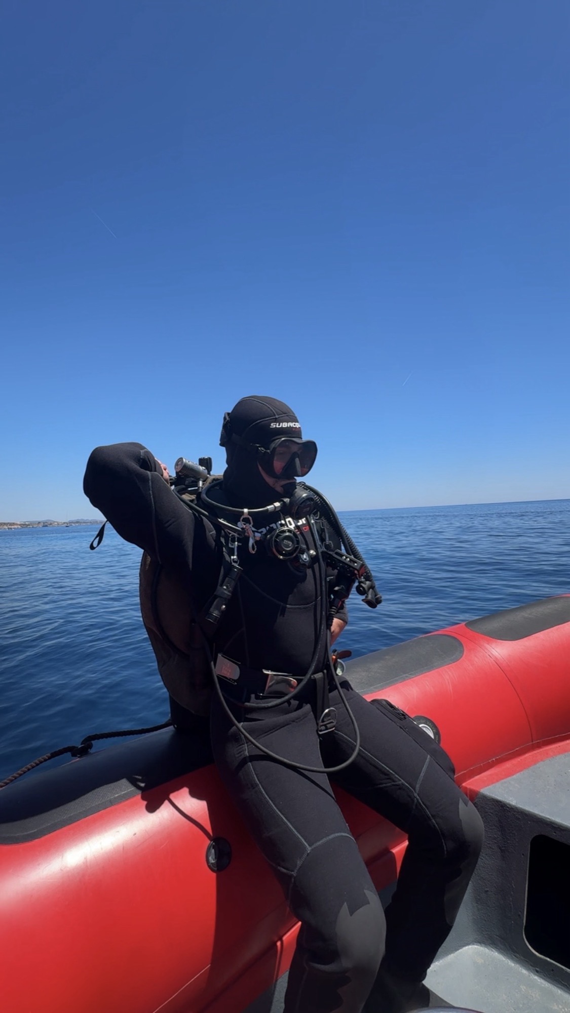 Diver gearing up on a RIB boat before a technical dive