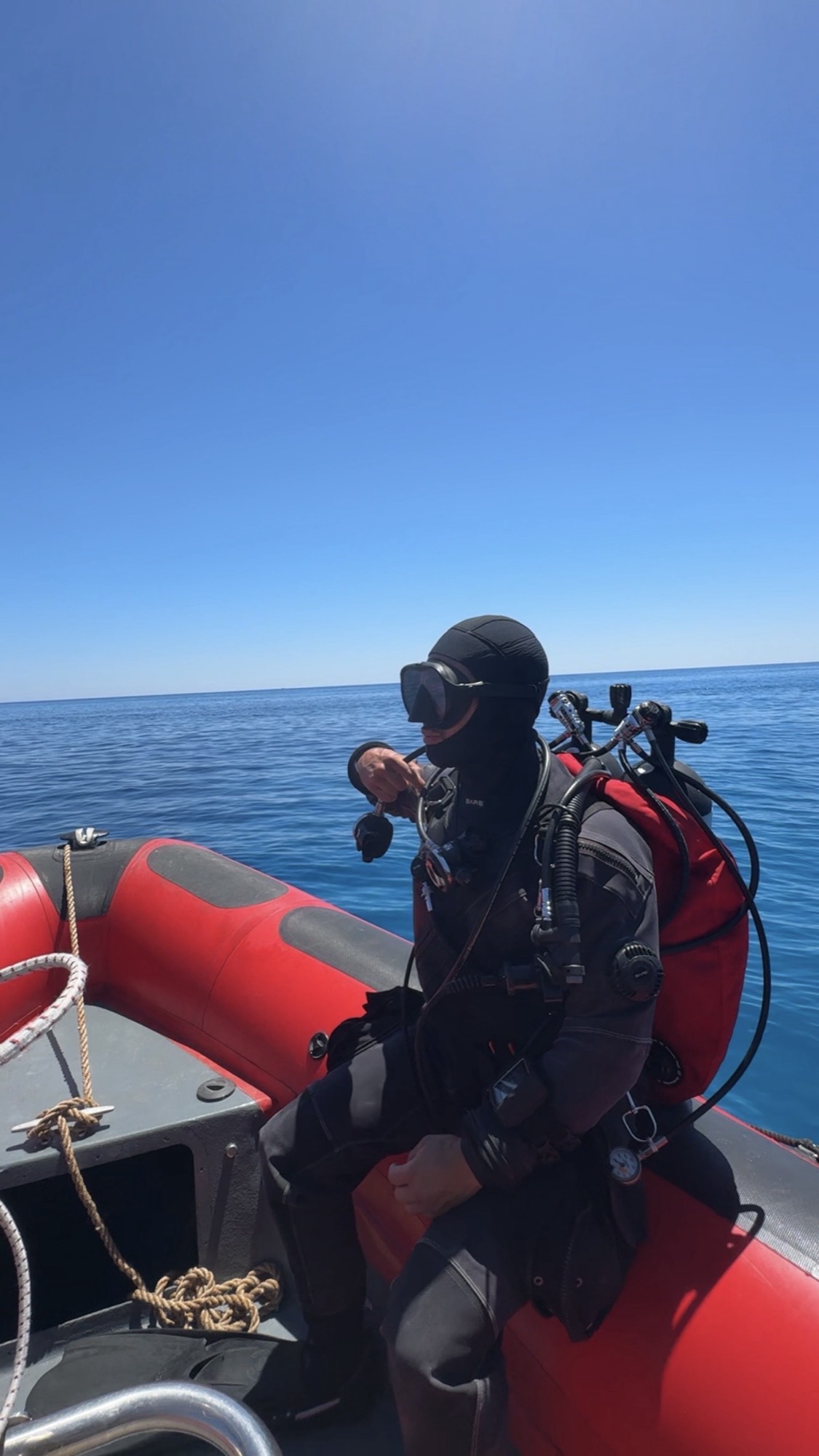 Technical diver geared up on a boat in Mallorca before a dive